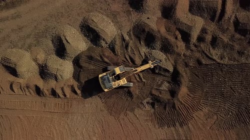 Excavator Digging Dirt in a Rural Area