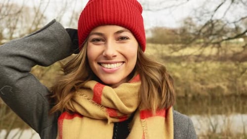 Smiling Woman in Red Hat Outdoors in Autumn