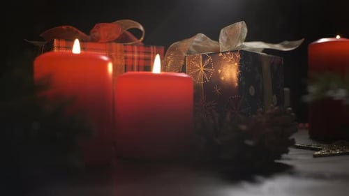 Candles and Christmas Gifts on Dark Background