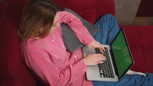 Businesswoman Working on Laptop Green Screen Chromakey on Sofa at Home