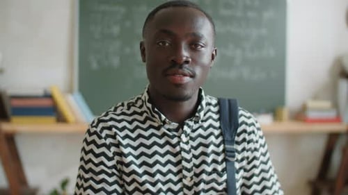 Young Man with Backpack in Classroom