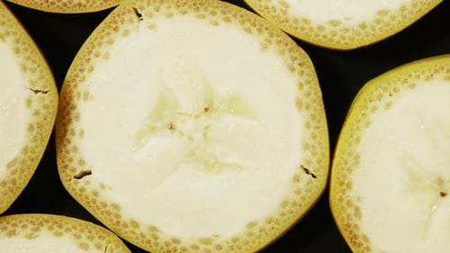 Macro View of Banana Slices Rotation. Extreme Closeup of Yellow Juicy Texture of Exotic Fruit