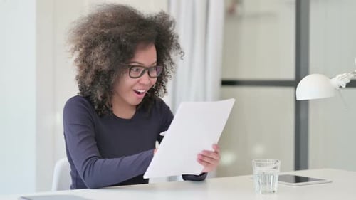 Woman Smiling While Working with Documents Indoors