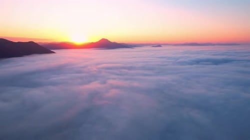 4K Aerial video Beautiful sunrise above dense clouds and fog in the morning