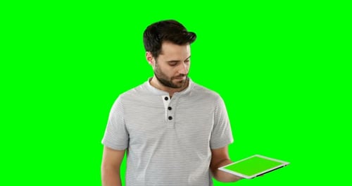 Man Using Tablet with Green Screen Background