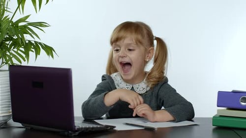 Little Girl Learning Online with a Laptop