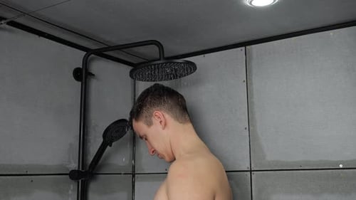 Young Man Taking Shower in Modern Bathroom