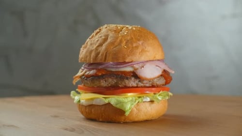 A Delicious Cheeseburger Served on a Wooden Platter