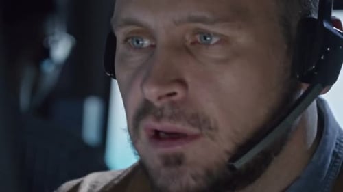 Man Wearing Headset Working in an Office