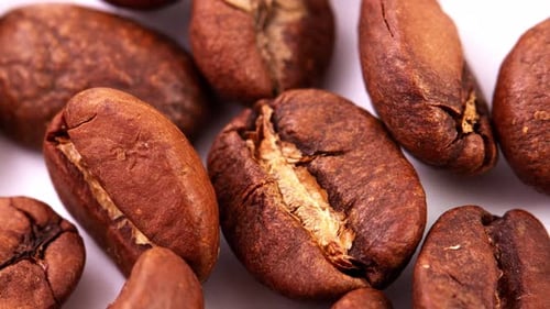 Extreme Close Up of Roasted Coffee Beans Panning