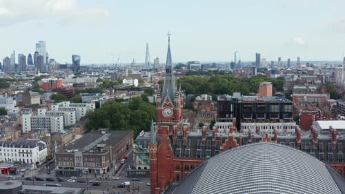 Elevated Static Shot of Historic Brick Tower Contrasting with Modern Tall Buildings in City