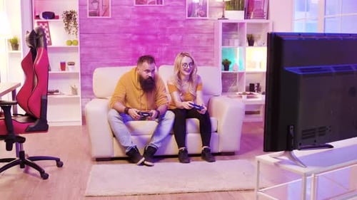 Couple Relaxing, Playing Video Games in Living Room