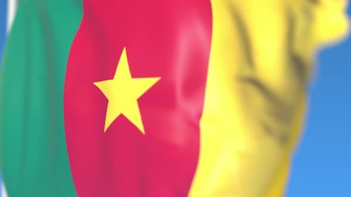 Realistic Waving Flag of Cameroon Against Blue Sky