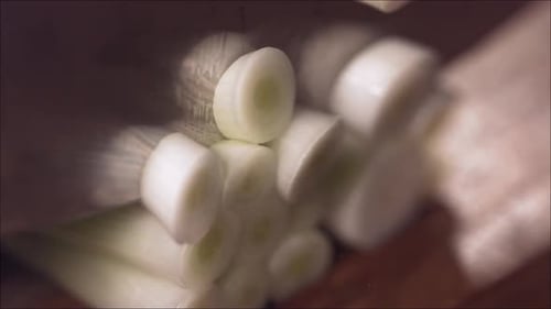 Cutting Fresh Green Onions on a Cutting Board