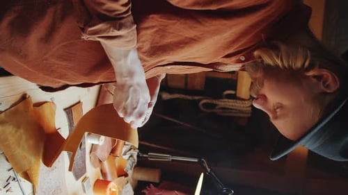 Man Working with Leather in Workshop