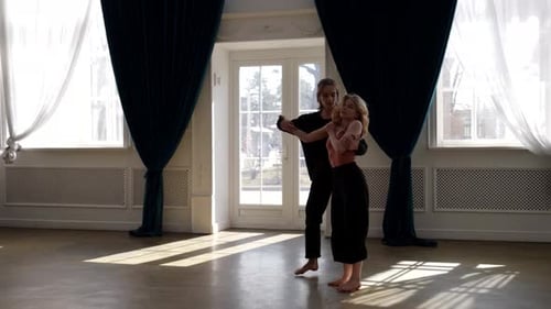 Couple of Young Dancers is Rehearsing in Dance Hall Young Man and Woman are Dancing Together