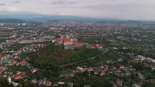 Aerial View of Medieval Castle on Mountain in Small European City at Cloudy Autumn Day
