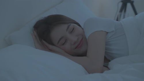 Asian beautiful woman lying down on bed in bedroom, dreaming at night.