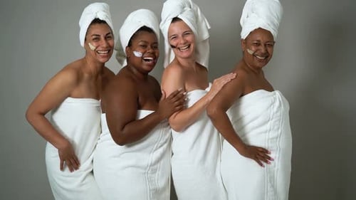 Happy multiracial females with different body size having skin care spa day