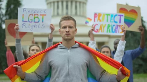 People Holding Rainbow Flag Advocating For Equal Rights
