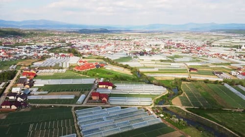 Aerial View of Greenhouses and Rural Landscape