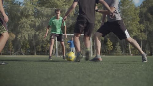Street Soccer Players Playing Game on the Pitch