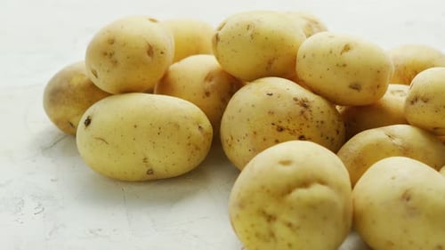 Pile of Yellow Potatoes on White Surface