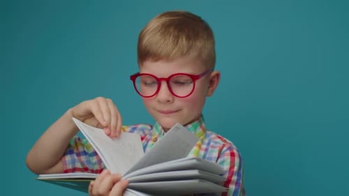Boy with Glasses Reading a Book