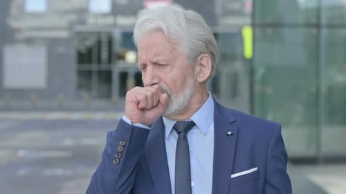 Man Coughing in Urban Environment