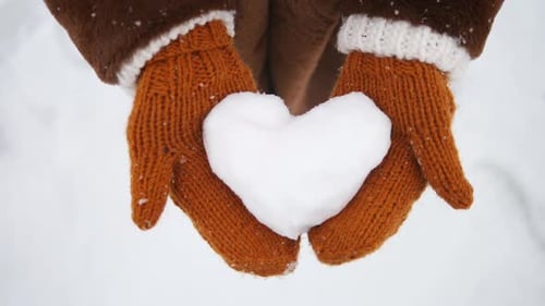 Heart Shaped Snowball Held with Knitted Gloves