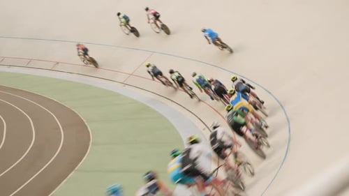 Track cycling teams training and racing on velodrome