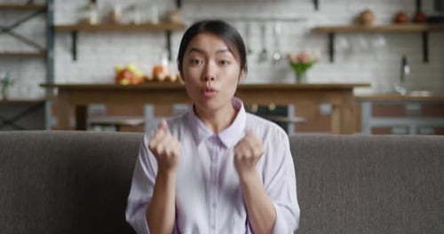 Excited woman celebrates and raises arms in success