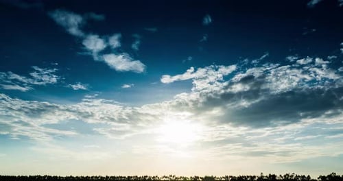 Timelapse of cloud on the sky and meadow with sunset