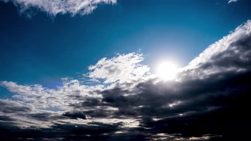 Amazing Dramatic Storm Clouds Move in the Blue Sky. Time Lapse. Sunbeams Shine.
