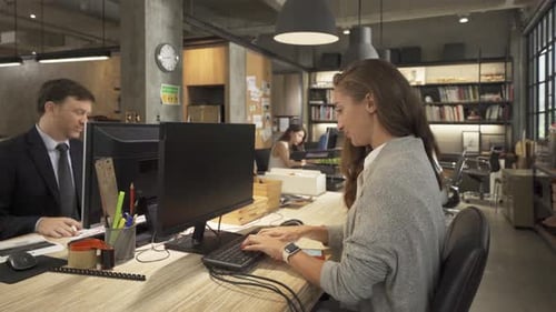 Employees Working Together in Modern Open Office