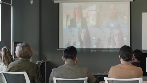 Businesspeople Talking on Video Call with Colleagues in Office