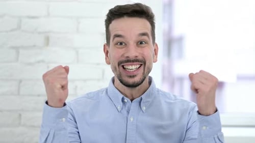 Excited Young Adult Celebrates Success