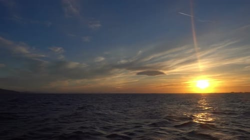 Sun In The Clouds At Sunset Over The Sea