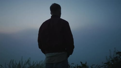 Relaxed Man Enjoying Sunrise in Field