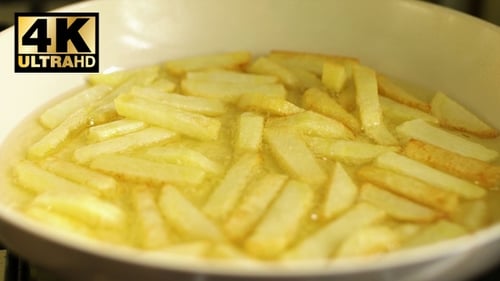 French Fries Sizzle and Bubble in Pan of Oil