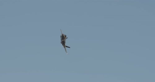 Fighter Jet Soaring Across Blue Sky
