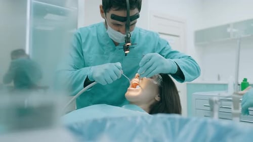 Dentist Examining Patient's Teeth in Bright Office