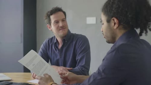 Business colleagues reviewing document together