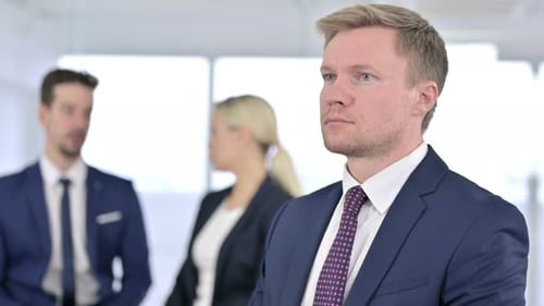 Portrait of Serious Businessman Looking at the Camera in Office