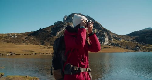 Woman Hiker Photographs Stunning Lake and Mountain View