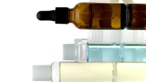 Cosmetic Bottles and Soap Still Life on White