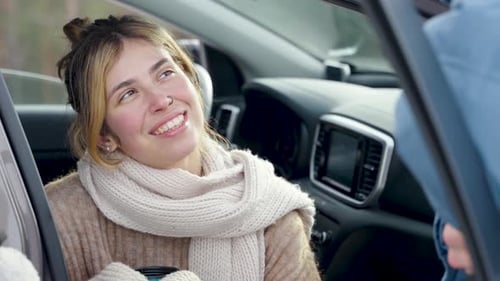 Smiling Woman Conversing in Car on Winter Day
