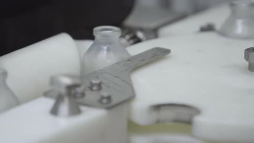 Glass Bottles on Medical Solution Conveyor Line Close Up Selective Focus
