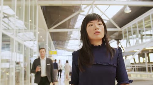 Business Woman Walking with Phone in Modern Office