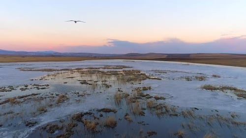 Icy Lake and Fields at Colorful Sunrise